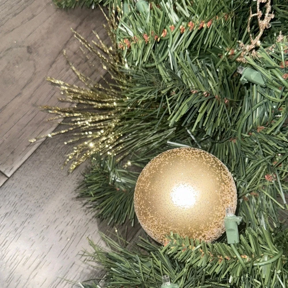 Festive Green Holiday Garland with Gold Accents and lights
